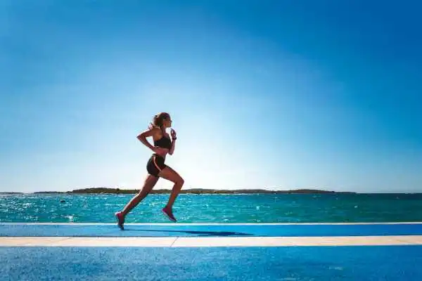 Woman running showing strong leg muscle Stamford